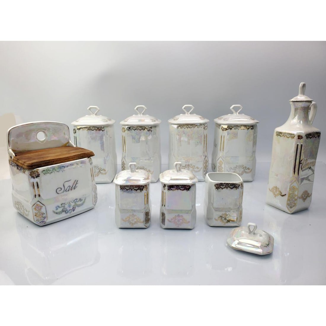 9 Vintage Czechoslovakia Iridescent Porcelain Item: Lot of 9 Vintage Czechoslovakia Iridescent Porcelain Items Including Canisters, Salt Cellar, and a Vinegar Holder. Condition: Generally Good. Salt Cellar has a Repair. Dimensions: Each Large Canister-