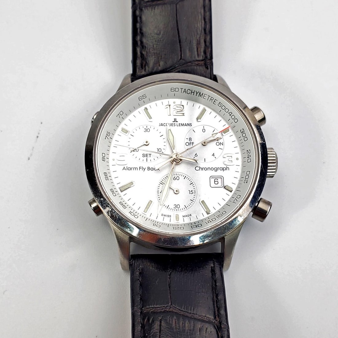 Jaques Lemans Chronograph Mens Watch: Jaques Lemans Chronograph Mens Watch with Black Leather Strap. Please Note-We Do Not Guarantee The Workability of Any Used Watches.Condition: Generally Very Good. Dimensions: Face Dia-1.5". Provenance