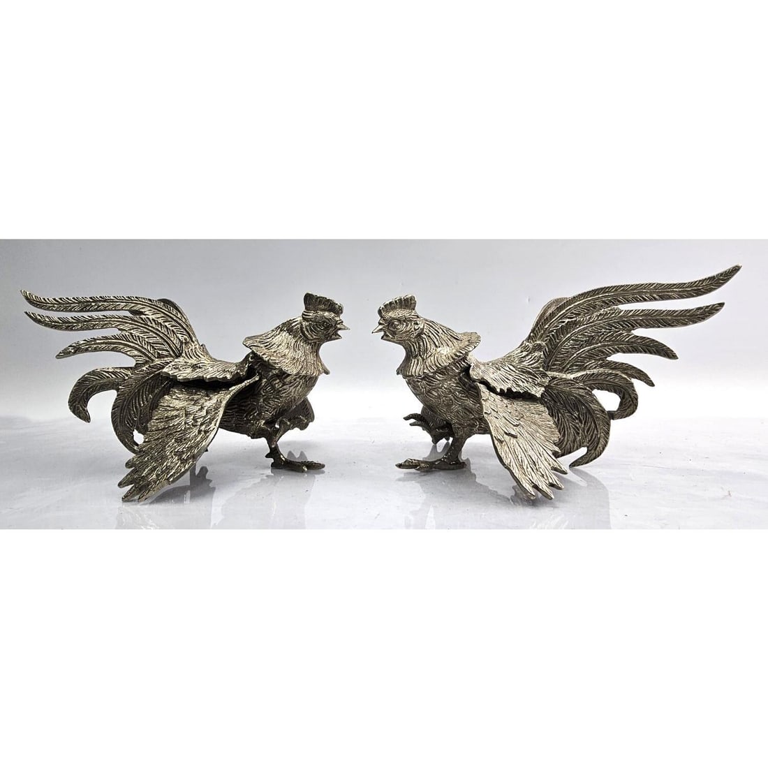 Pair of Vintage Silver-Plated Rooster Sculptures: Pair of Vintage Silver-Plated Rooster Sculptures. Condition: Generally Very Good. Dimensions: L-8" x W-4" x H-4". Provenance: From a Long Island, NY Home. Please note the absence of a Condition Report