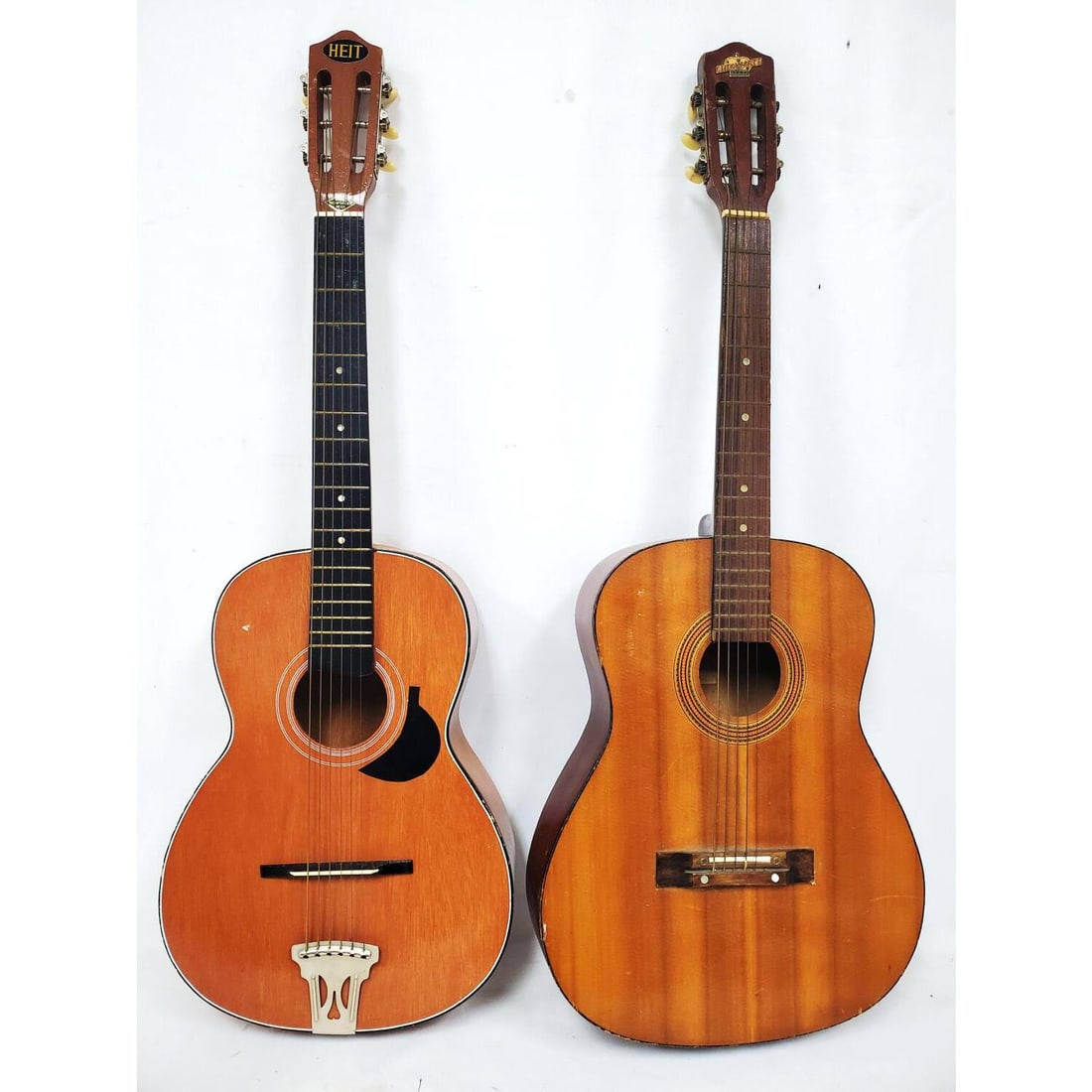 Lot of 2 Vintage Guitars: Lot of 2 Vintage Guitars. 1 is Checkmate (Missing a Key). The Other is Heit (Made in Japan) In Original Cover. Condition: Generally Good. As Is. Dimensions: L-36.75".Provenance: From a Garden City, NY