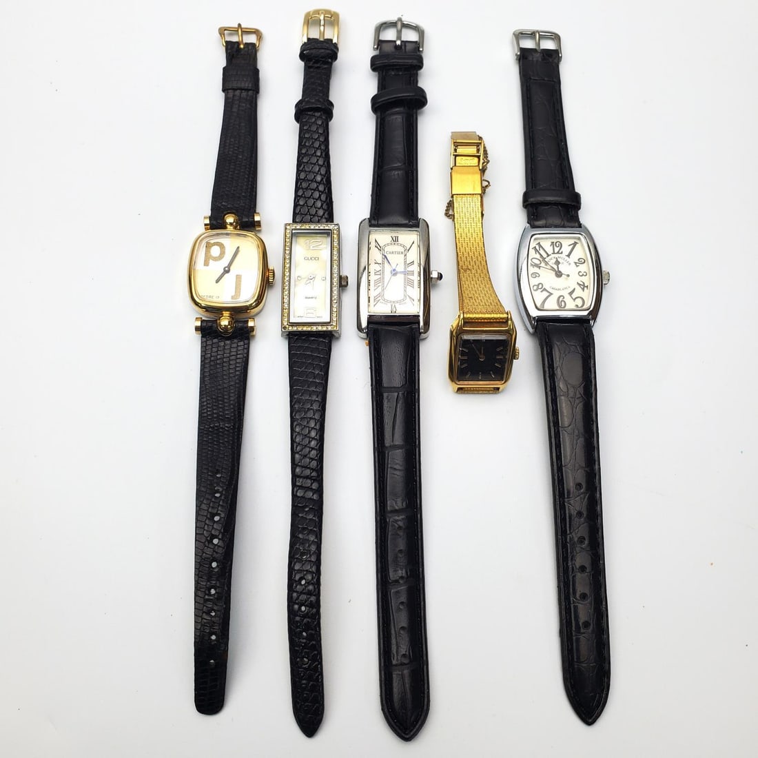 Lot of 5 Watches. NOT AUTHENTIC: Lot of 5 Watches. NOT AUTHENTIC. Condition: Generally Good, However, We Do Not Guarantee the Workability or Mechanism of Old Watches. Dimensions: Various Sizes. Provenance: From a Long Island, NY Home