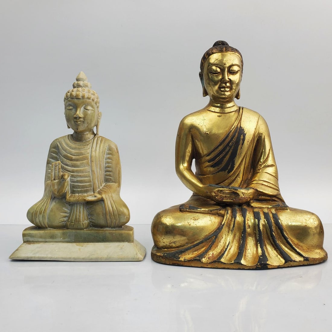 Lot of 2 Buddha Figures Incl. Brass & Soapstone: Lot of 2 Buddha Figures Including 1 Brass & 1 Carved Soapstone. Condition: Generally Very Good. The Brass Has Some Paint Losses & Is Dirty. Dimensions: Larger-L-6.5" x W-5" x H-8.25". Provenance: From