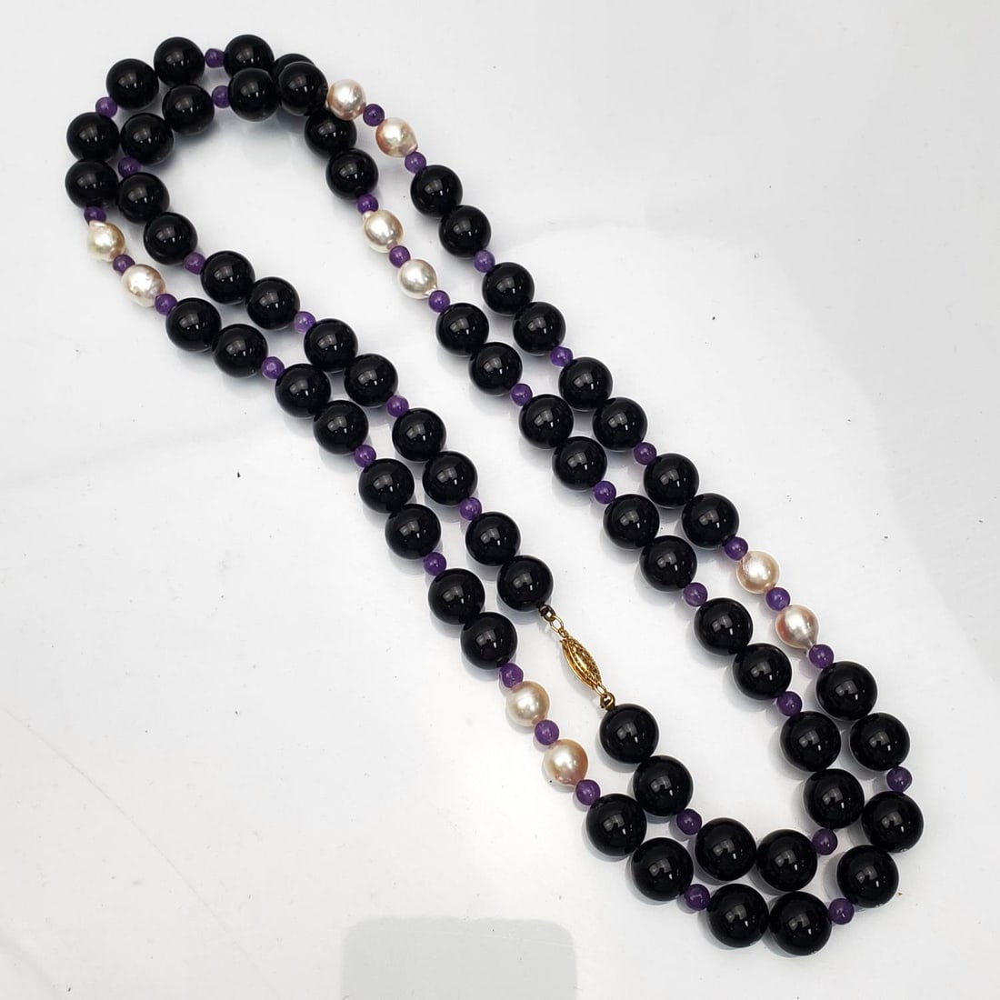 Onyx & Pearl Necklace w/ 14K Gold Clasp: Onyx & Pearl Necklace w/ 14K Gold Clasp. Condition: Excellent. Dimensions: L-35". Gross Weight: 108.9g. Provenance: From a New York City Home. Please note the absence of a Condition Report does not im