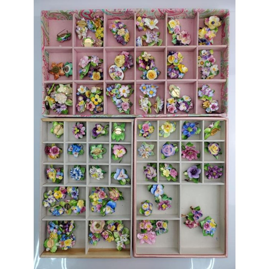 Group Lot of Over 100 Porcelain Flower Pins: Group Lot of Over 100 Porcelain Flower Pins & Brooches. Condition: Very Good. A Few Pins Have Minor Chips. Dimensions: Various Sizes But Around 2" in Diameter Each. Provenance: From a Long Island, NY 