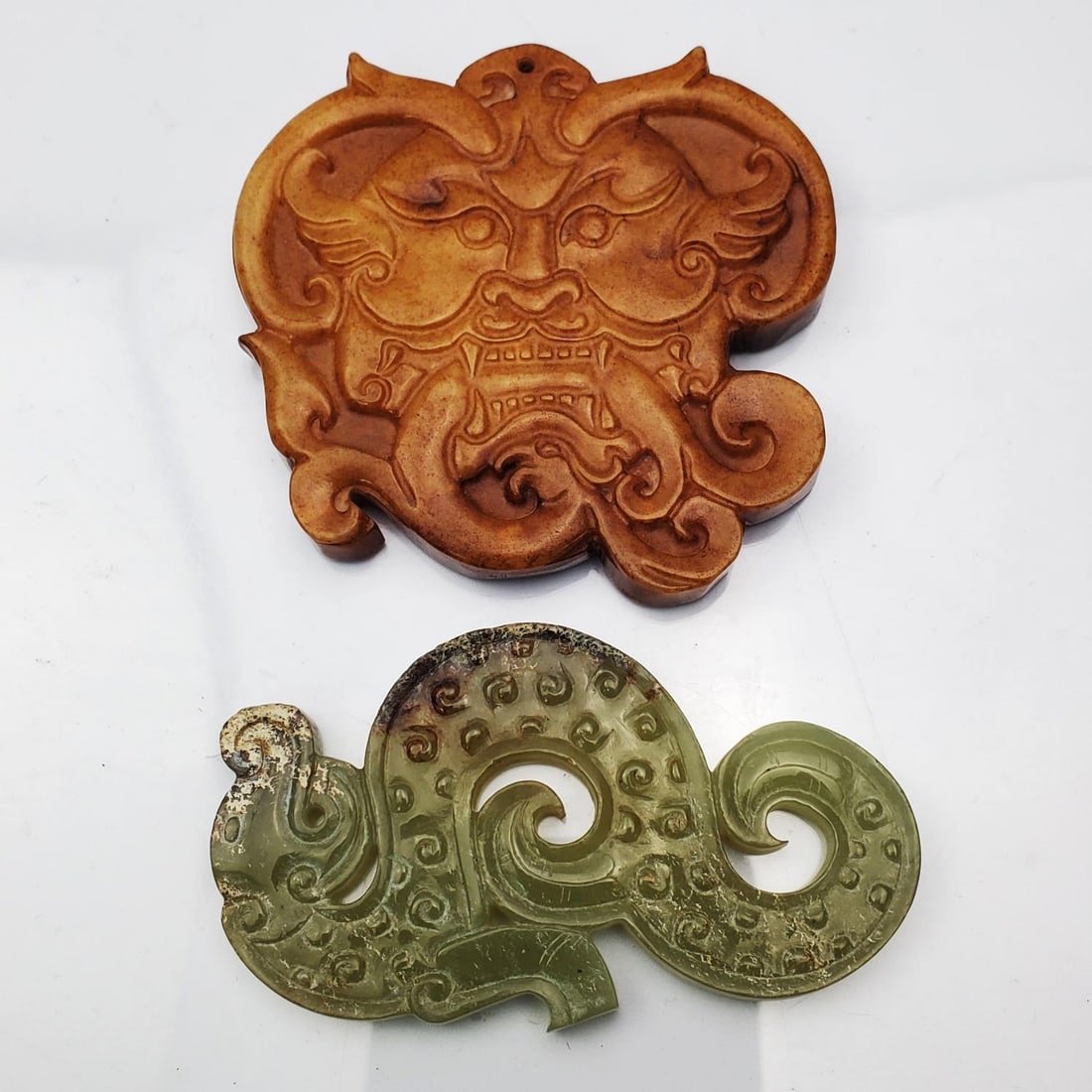 Chinese Carved Celadon Jade Dragon: Chinese Carved Celadon Jade Dragon Along w/ a Carved Stone Plaque. Condition: Generally Good. Dimensions: Larger-2.75" x 2.75". Provenance: From a Long Island, NY Home. Please note the absence of a Co
