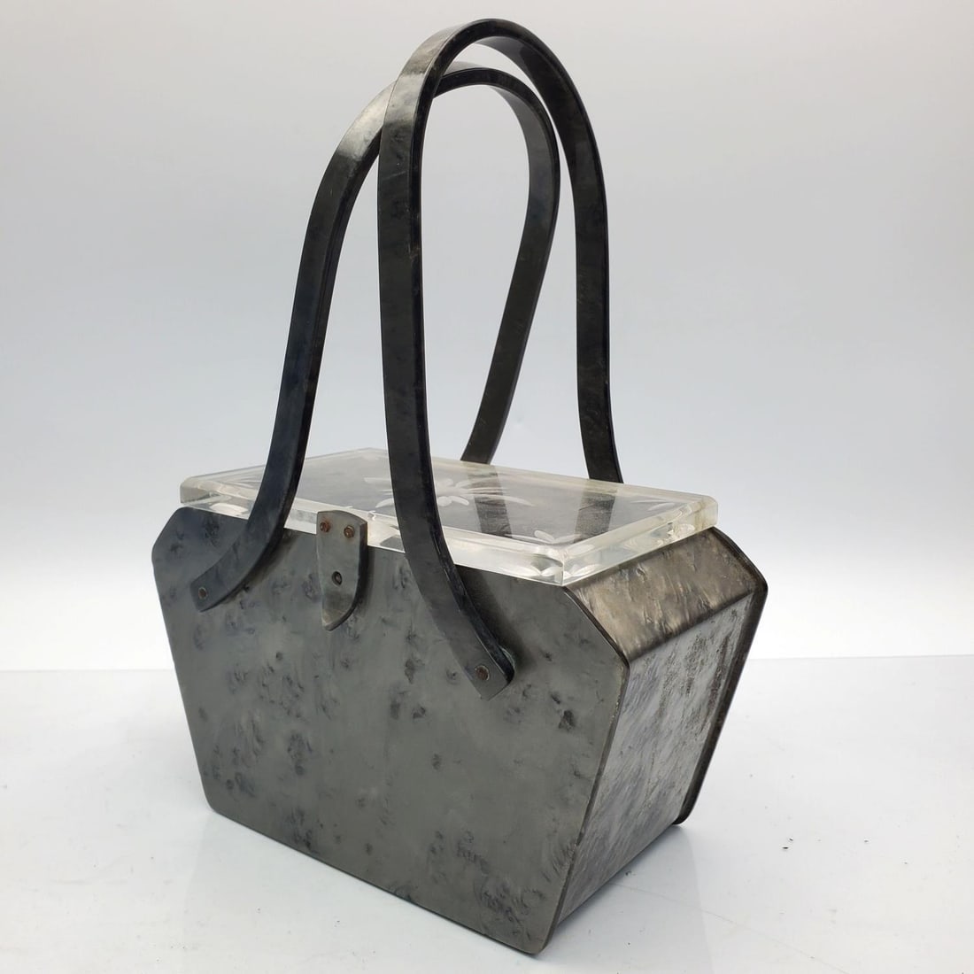 Old Lucite Bag, Circa 1930s or 1940s: Old Lucite Bag. Circa 1930s or 1940s. Condition: Generally Good. Minor Crack on the Side. Dirty. Needs Cleaning. Dimensions: Total H-10.25" x L-7.5" x W-3.6". Provenance: From a New York City Estate. 