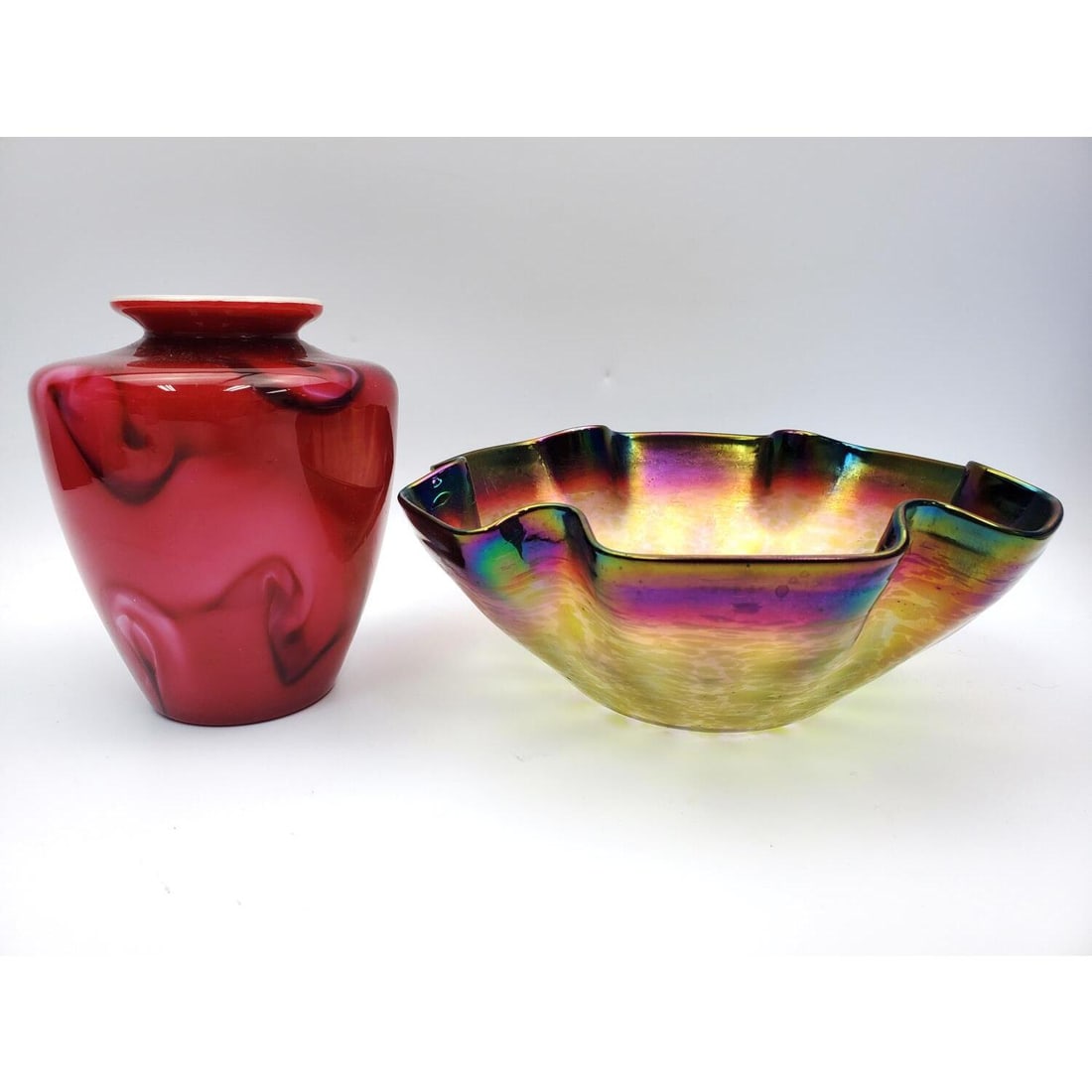Lot of 2 Loetz Style Art Glass Items: Lot of 2 Loetz Style Art Glass Items Including an iridescent Bowl & a Marbleized Red Over White Vase.Condition: Excellent. Dimensions: Bowl-Dia-8.6" x H-3.4". Provenance: From a Long Island, NY Home.