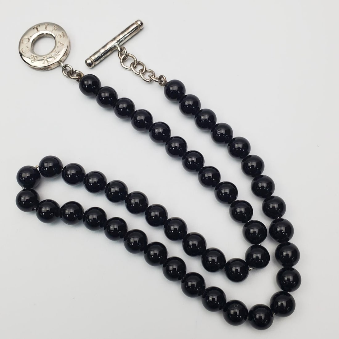 Tiffany & Co. Black Onyx Bead Toggle Necklace: Tiffany & Co. Black Onyx Bead Toggle Necklace. Condition: Generally Very Good. Dimensions: L-17.25". Total Weight: 44.2g. Provenance: From a Long Island, NY Home. Please note the absence of a Conditio