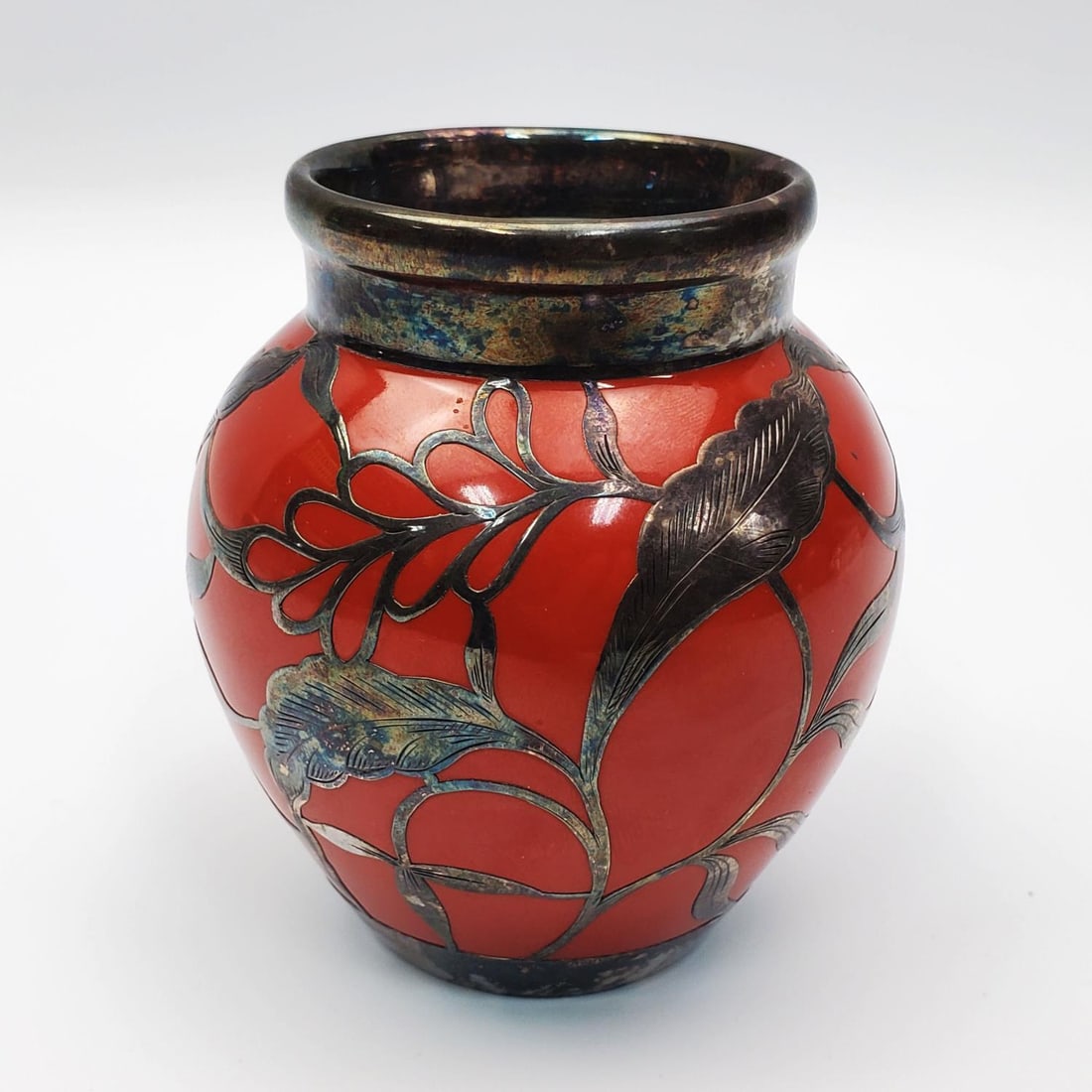 Antique German Art Nouveau " Hutschenreuther" vase: Antique German " Hutschenreuther " Art Nouveau Silver Overlaid Porcelain Vase Signed "Hutschenreuther Hohenberg Bavaria". Condition: Generally Very Good w/ Some Tarnishing. Dimensions: Dia-2" x H-3.5"