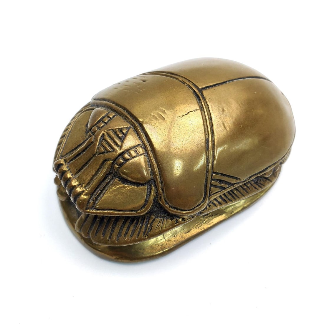 Egyptian Bronze Scarab Paperweight w/ Hieroglyphic: Egyptian Bronze Scarab Paperweight w/ Hieroglyphics on The Bottom. Condition: Generally Very Good. Dimensions: L-3.3" x W-2.1" x H-1.5". Provenance: From a Long Island, NY Home. Please note the absenc