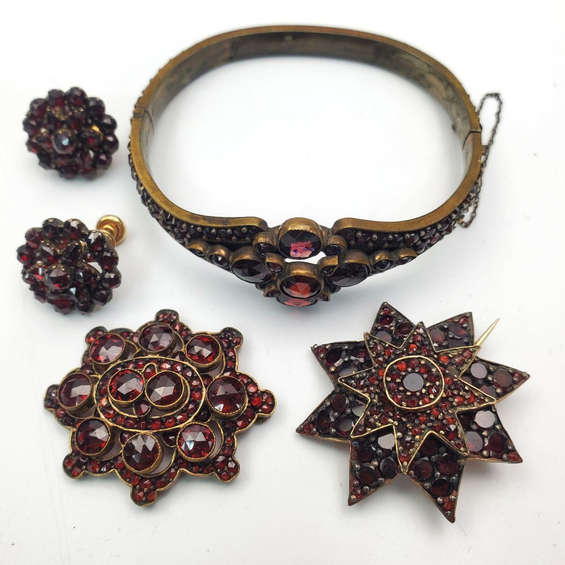 Lot of Antique Garnet Jewelry Items: Lot of Antique Garnet Jewelry Items Including a Pair of Earrings, a Bracelet, a Brooch, & a Pendant. Condition: Generally Good. Dimensions: Bracelet-Dia-2.4". Provenance: From a Long Island, NY Home. 