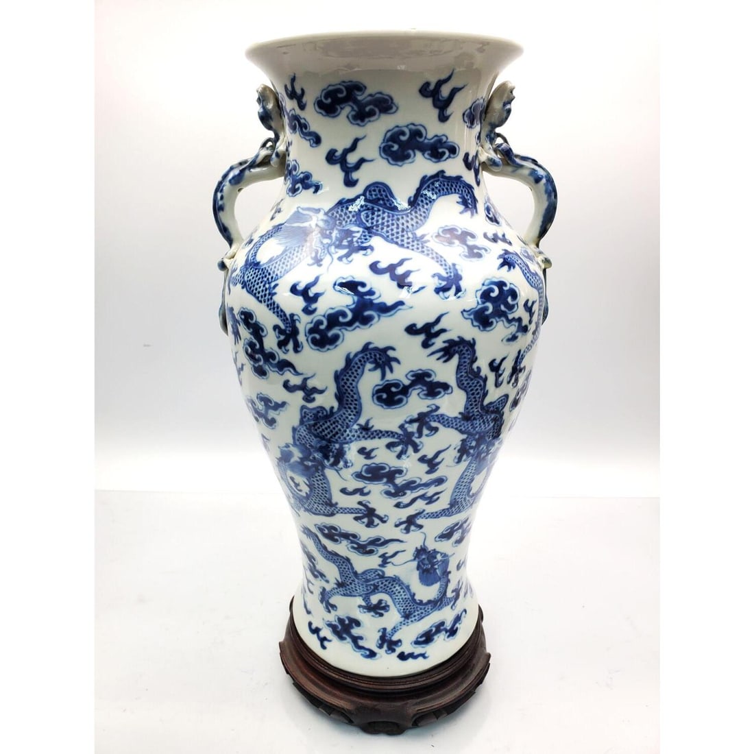 Antique Signed Chinese Blue & White Porcelain Vase: Antique Signed Chinese Blue & White Porcelain Vase w/ Decorations of Dragons w/ Handles that are in the Shape of Dragons. Along w/ a Wood Stand. Condition: Generally Very Good. 1 Handle has Old Restor