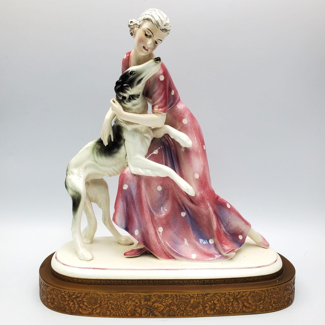 Vintage Hertwig & Co German Porcelain Figure 1930s: Vintage Hertwig & Co. German Porcelain Figure of "Woman w/ Her Greyhound Dog". Circa 1930s. Condition: Generally Very Good. Dimensions: L-10.25" x W-4.75" x H-10.5". Provenance: From a Long Island, NY