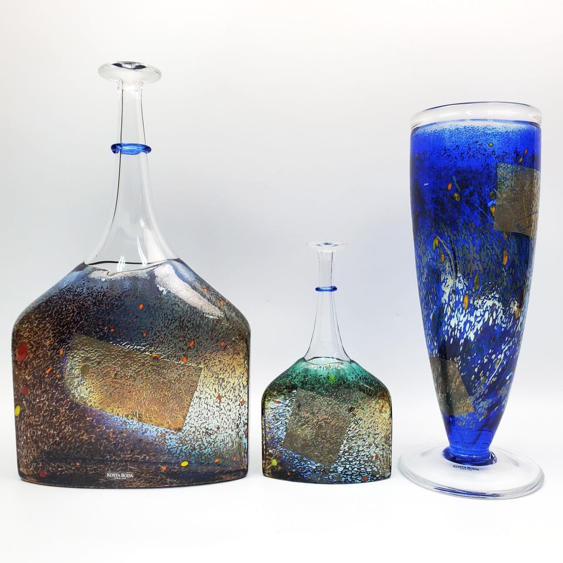 3 Vintage Kosta Boda Satellite Art Glass Vases: Lot of 3 Vintage Kosta Boda Satellite Iridescent Art Glass Vases Designed by Bertil Vallien. One is in the Shape of a Bottle. All Are Fully Signed & Numbered At The Bottom. Circa 1990s. Condition: Exc