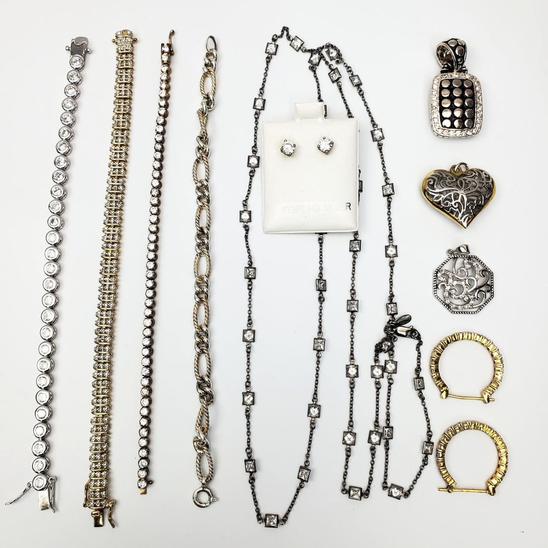 Lot of Silver Jewelry Items: Lot of Silver Jewelry Items Including Bracelets & Pendants. Condition: Generally Good. Dimensions: Various Sizes. Gross Weight: 99.7g / 3.195ozt. Provenance: From a Long Island, NY Home. Please note t