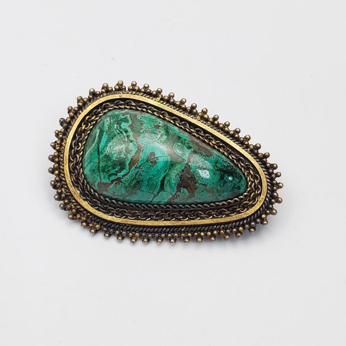 Israeli Sterling Silver Bezalel Style Brooch: Vintage Israeli Sterling Silver & Gold Gilt Bezalel Style Brooch/Pendant w/ Green Stone Insert. Fully Marked on Back. Condition: Generally Very Good. Dimensions: H-2" x W-1.25". Gross Weight: 29.1g/0.