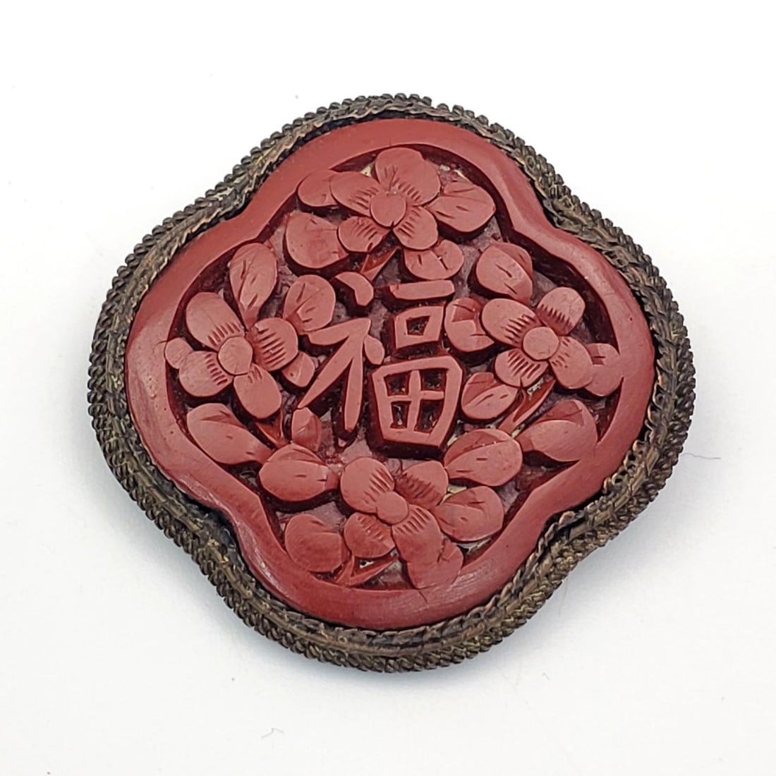 Chinese Cinnabar Brooch: Chinese Cinnabar Brooch. Condition: Generally Good. Dimensions: Dia-1.5". Provenance: From a Long Island, NY Home. Please note the absence of a Condition Report does not imply that there are no condit