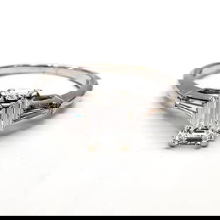 14K White Gold & Emerald Cut Diamond Ring: 14K White Gold & Emerald Cut Diamond Ring. The Center Diamond is Approximately 0.75 Carats & There Are 2 Baguette Diamonds on the Sides. Condition: Excellent. Dimensions: Ring Size-5.75. Gross Weight: