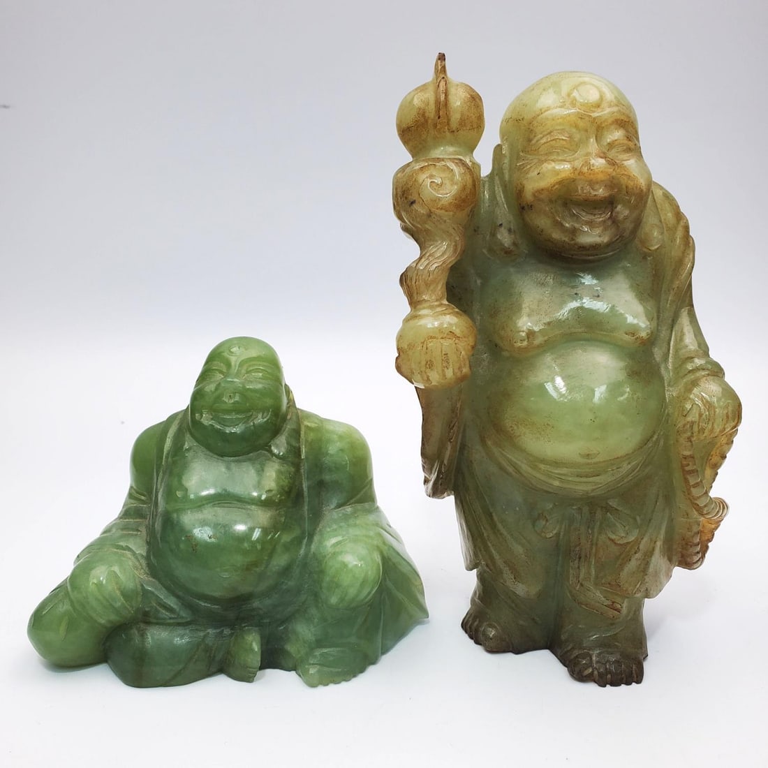Lot of 2 Chinese Carved Jade Figures of Buddha: Lot of 2 Chinese Carved Jade Figures of Buddha. Condition: Generally Good. Dimensions: Taller H-6.3". Provenance: From a Long Island, NY Home. Please note the absence of a Condition Report does not im