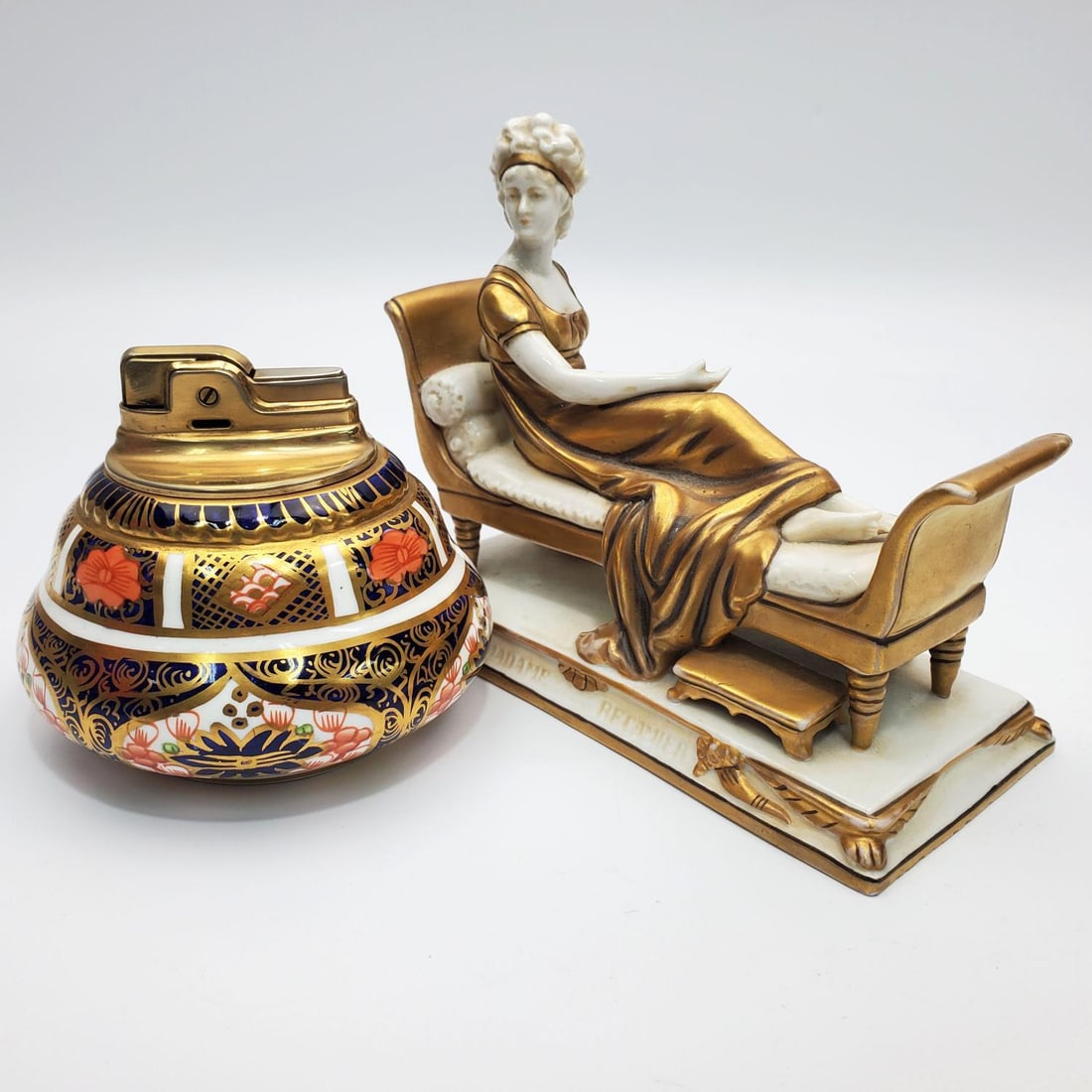 Royal Crown Derby English Porcelain Lighter Holder: Royal Crown Derby English Porcelain "For Ronson" Lighter Holder Along w/ a Italian Porcelain Figure of a Reclining Lady. Condition: Generally Very Good. Dimensions: Lighter Holder- Dia 3.5" x H-2.75".