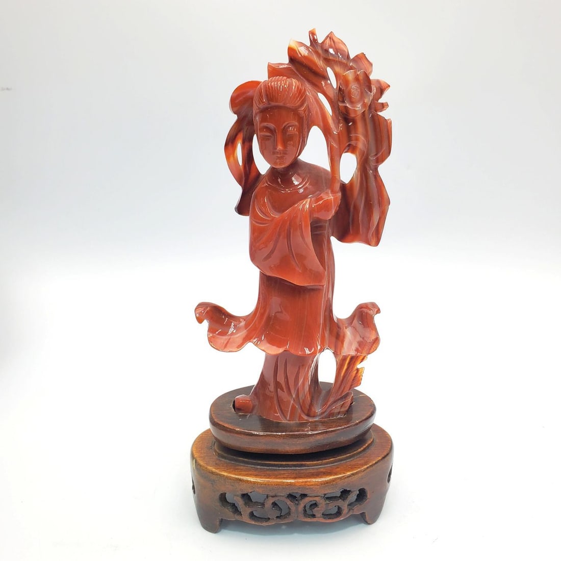 Chinese Carved Agate of Guanyin on Wood Base: Chinese Carved Agate of Guanyin on Wood Base. Condition: Generally Very Good. Dimensions: H w/ Base- 7". Provenance: From a Long Island, NY Home. Please note the absence of a Condition Report does not