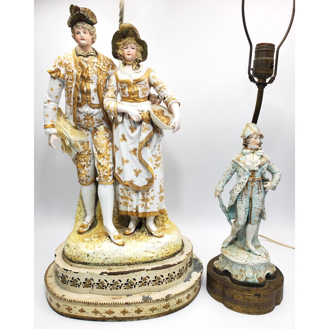 Lot of 2 Antique French Bisque Figurine Lamps: Lot of 2 Antique French Bisque Porcelain Figurines Made Into Lamps. The Large One Depicting a Man & Woman, The Other is a Soldier. Condition: Generally Good w/ Repairs & Restorations. Neither Porcelai