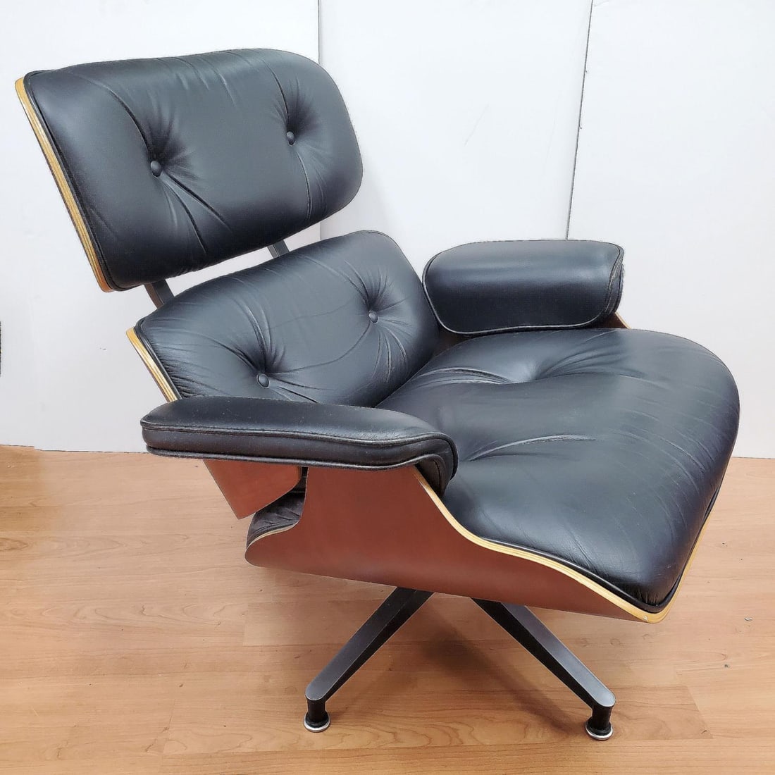 Eames Leather & Wood Lounge Chair: Eames Leather & Wood Lounge Chair. Condition: Generally Very Good. Ottoman is Missing. Dimensions: H-31.5" x W-31.5" x D-25". Provenance: From a Long Island, NY Home. Please note the absence of a Cond