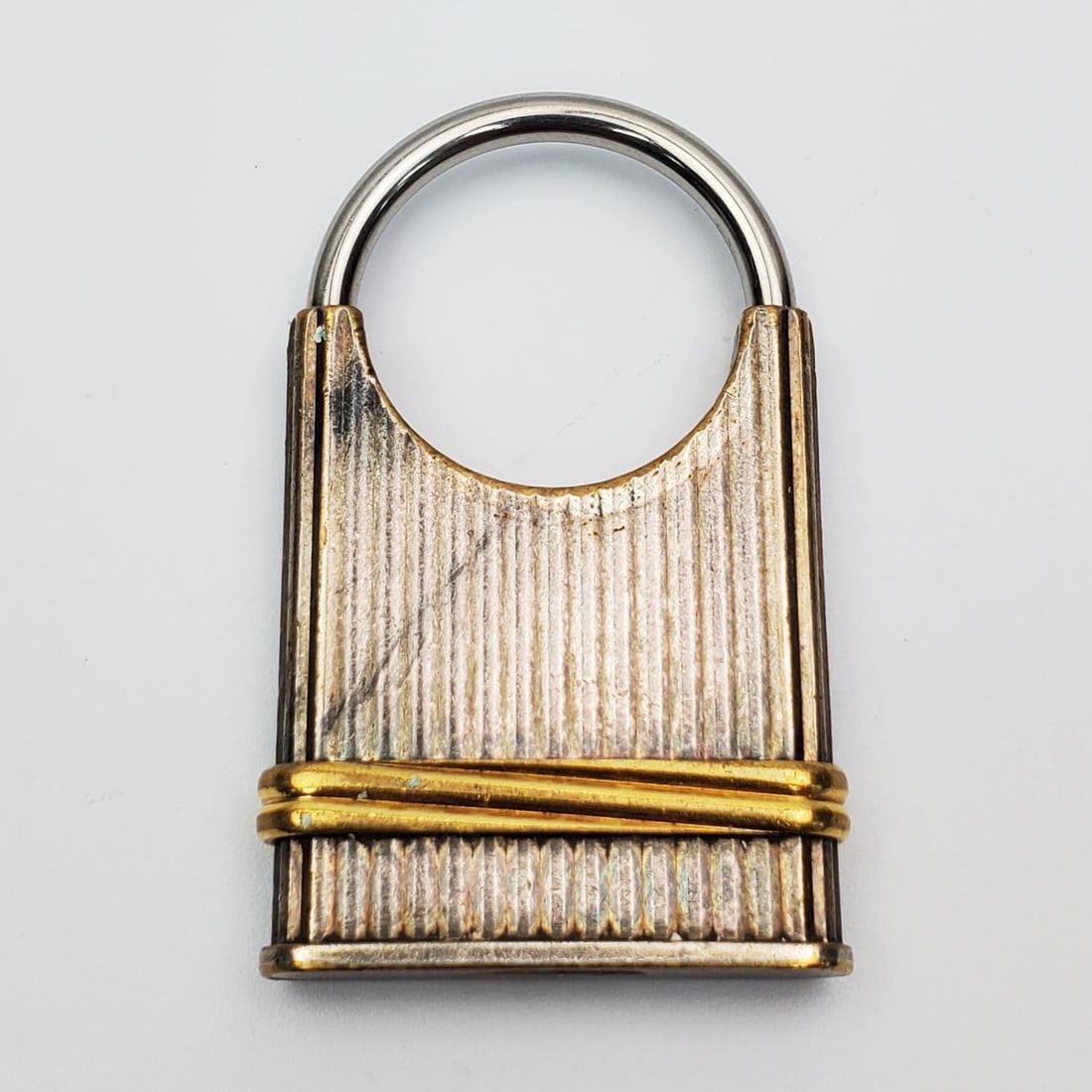 "Must De Cartier" Keychain: "Must De Cartier" Keychain. Serial #005167. Made in France. Condition: Generally Good w/ Some Tarnishing. Dimensions: L-2.25" x W-1.25". Provenance: From a Long Island, NY Home. Please note the absenc