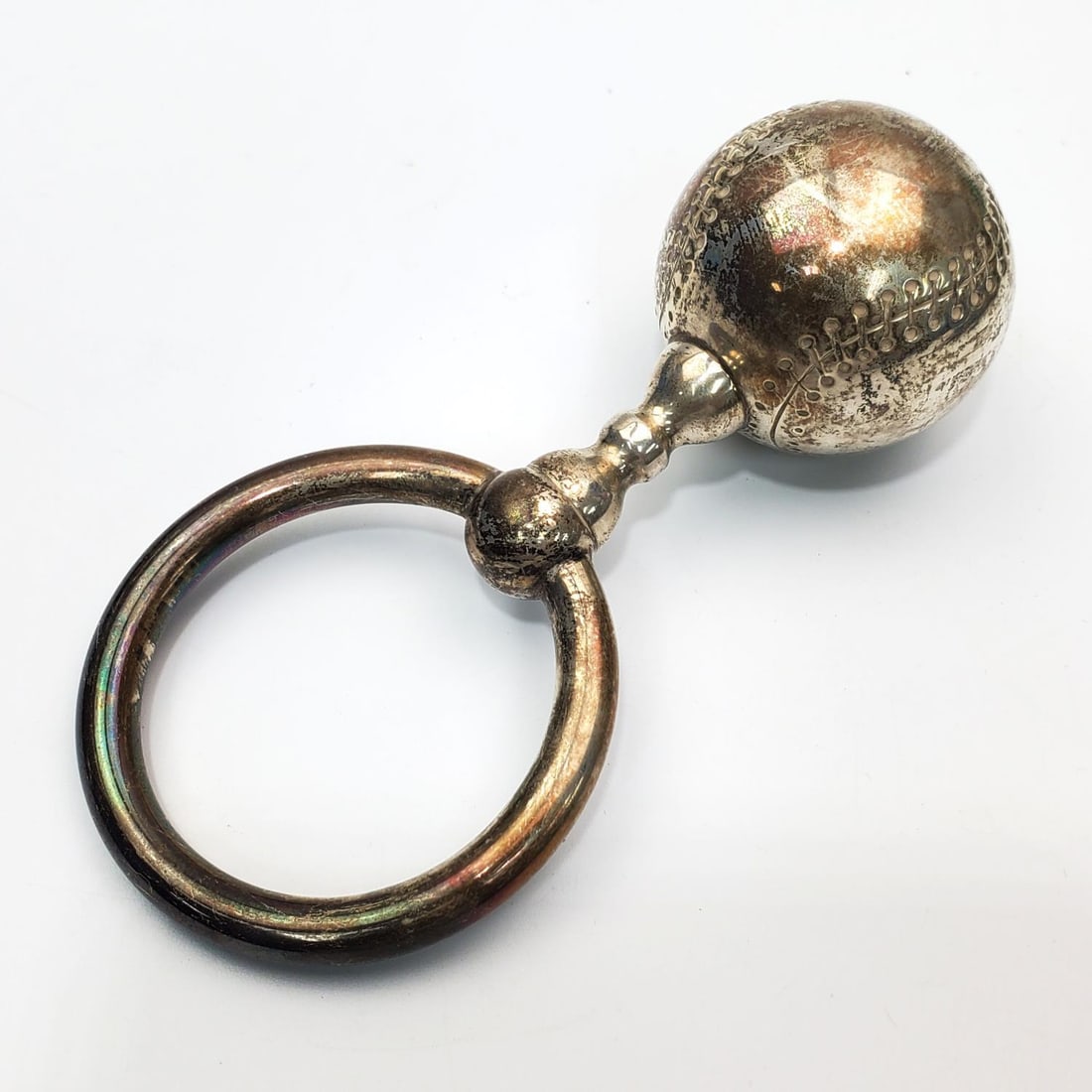 Vintage Tiffany & Co. Sterling Silver Baby Rattle: Vintage Tiffany & Co. Sterling Silver Baseball Shaped Baby Rattle. Condition: Generally Very Good w/ Some Tarnishing. Dimensions: L- 4.5" x W- 2.2". Weight: 43.5g / 1.4ozt. Provenance: From a Long Isl
