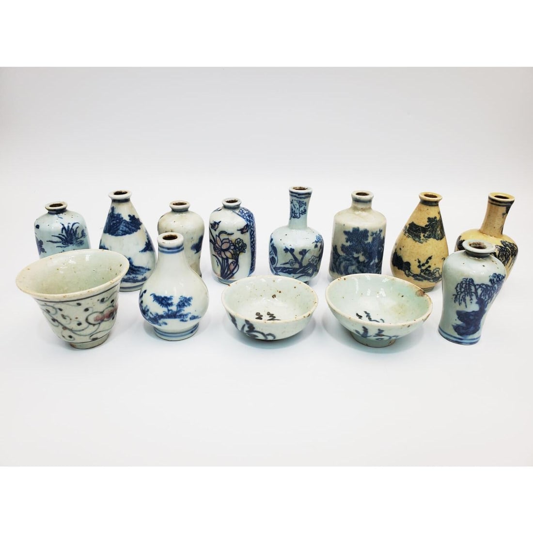 13 Chinese Blue & White Porcelain Miniature Items: Lot of 13 Chinese Blue & White Porcelain Miniature Items Including Vases & Cups. Some Are Signed. Condition: Generally Very Good. Dimensions: Largest-Dia-2.3" x H-2". Provenance: From a New Jersey Hom