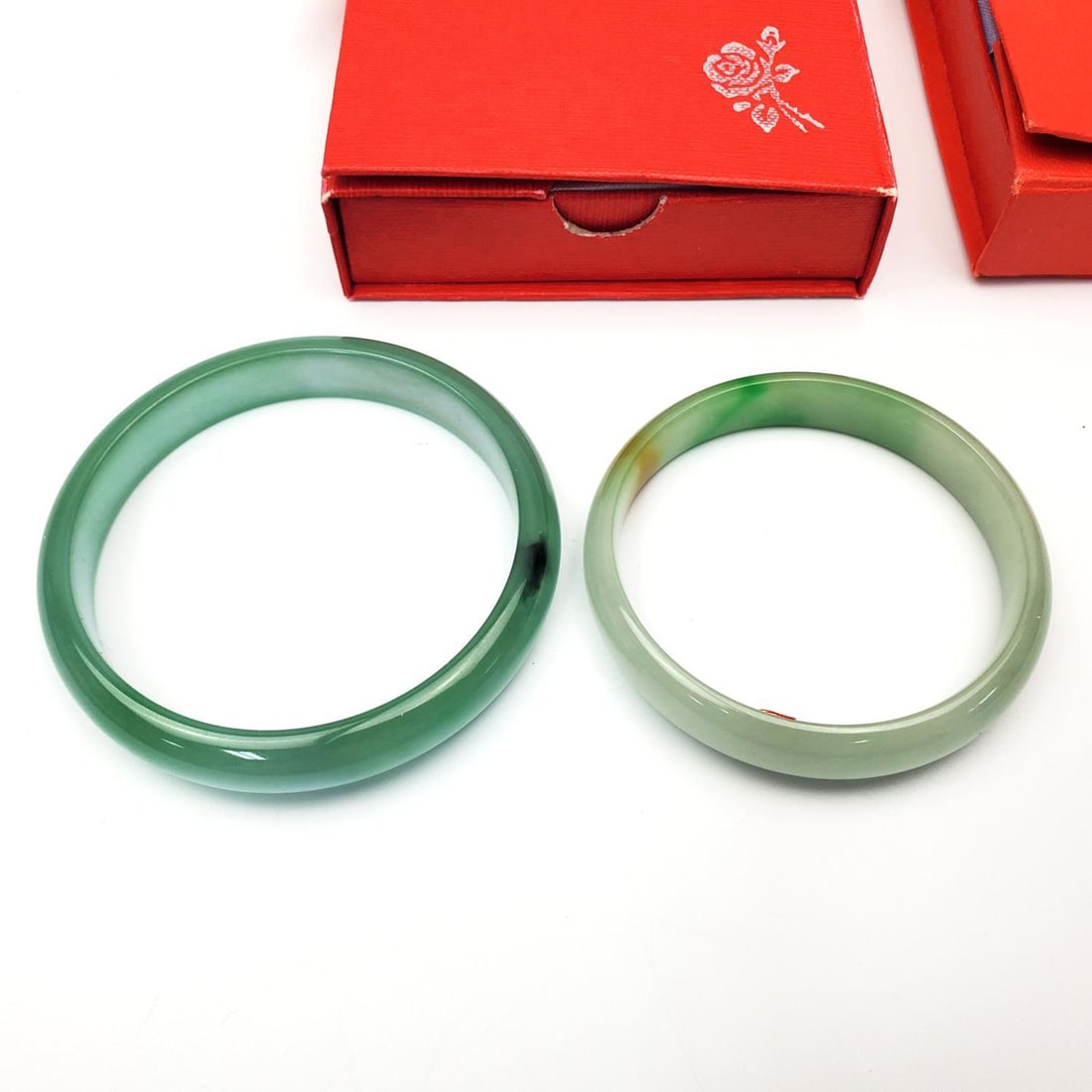 Lot of 2 Jade Bracelets: Lot of 2 Jade Bracelets in Original Fitted Boxes. Condition: Generally Very Good. Dimensions: Largest Inner Dia-2.25". Smaller Inner Dia-1.75". Box L-3.75" x 3.75". Provenance: From a Long Island, NY 