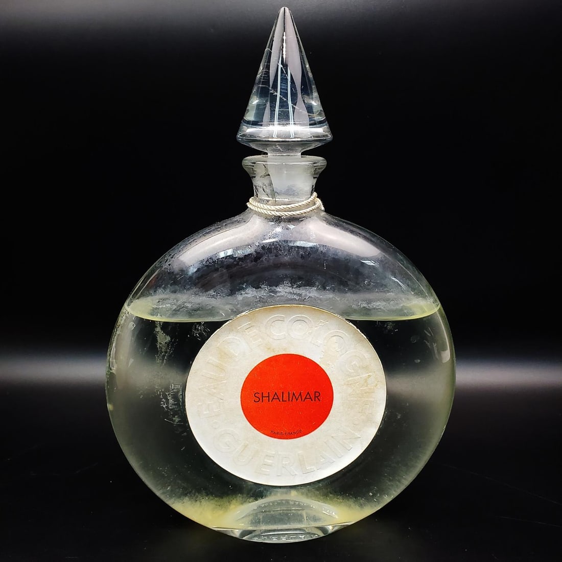 Shalimar Display Glass Perfume Factice Bottle: Large Shalimar Display Glass Perfume Factice Bottle. Fully Marked. Condition: Generally Good. Dimensions: H- 12" x W- 7.75". Provenance: From a Long Island, NY Collector. Please note the absence of a 