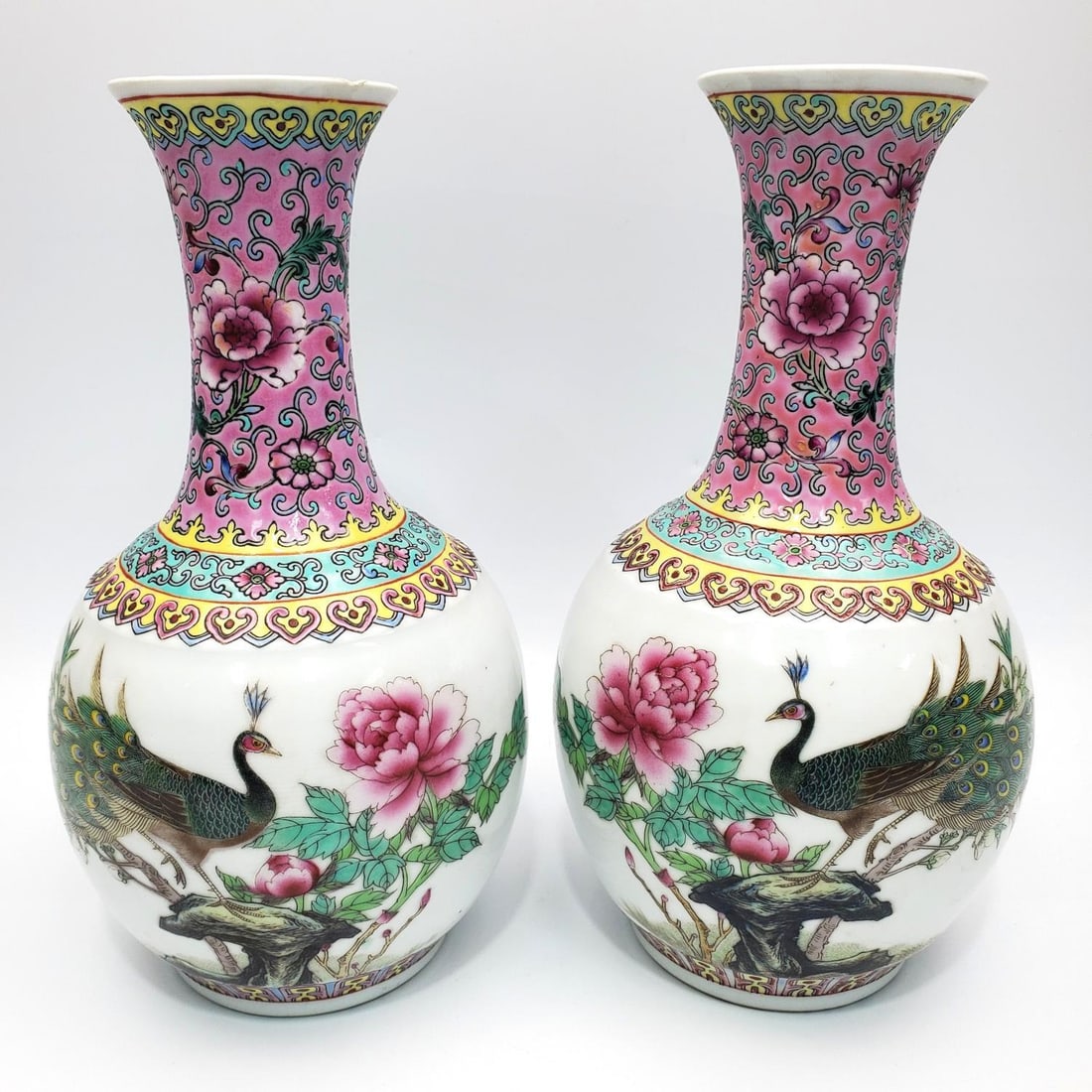 Pair of Chinese Famille Rose Porcelain Vases: Pair of Chinese Famille Rose Porcelain Vases Depicting Peacocks & Flowers. Condition: Generally Very Good w/ a Small Chip on The Top of 1. Dimensions: H- 9.5" x W- 5.25". Provenance: From a Long Islan