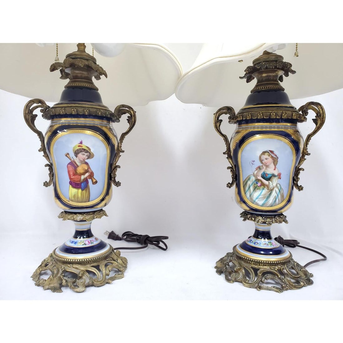 Pair Antique French Style Sevres Porcelain Lamps: Pair of French Sevres Style Porcelain & Bronze Mounted Table Lamps w/ Hand-Painted Floral Bouquets. Condition: Generally Very Good. Some Losses Due to Age. Please Note- We Do Not Guarantee the Workabi