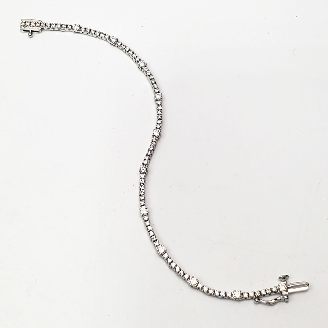 10K White Gold & Diamond Unusual Tennis Bracelet: 10K White Gold & Diamond Unusual Tennis Bracelet. Condition: Excellent. Dimensions: L-6.5". Gross Weight: 5.0g/3.2dwt. Provenance: From a Long Island, NY Home. Please note the absence of a Condition R