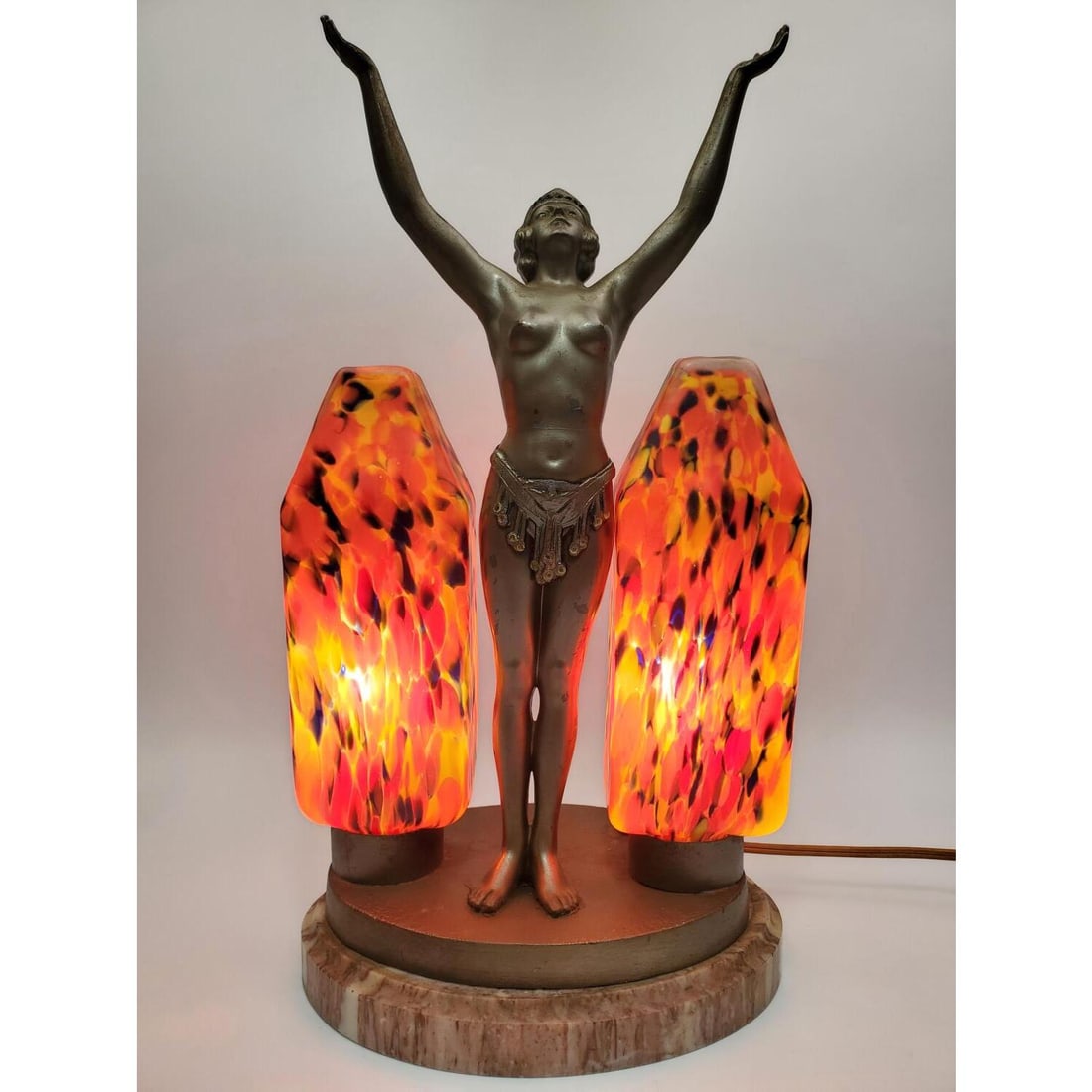 Art Deco Figural Metal Lamp w/ Glass Shades: Art Deco Figural Metal Lamp w/ Unusual Glass Shades on Marble Base. Condition: Generally Good. Some Chips on The Shades on The Bottom But Does Not Show When Attached to Lamp. Base is Slightly Wobbly.