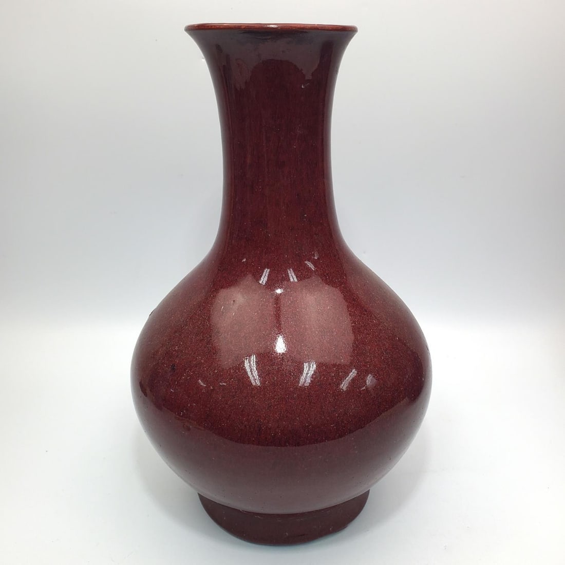 Chinese Sang De Boeuf Porcelain Vase: Chinese Sang De Boeuf Porcelain Vase. Condition: As Found. Dimensions: H-13.5" x Dia--9.5". Provenance: From a Long Island, NY Home. Please note the absence of a Condition Report does not imply that t