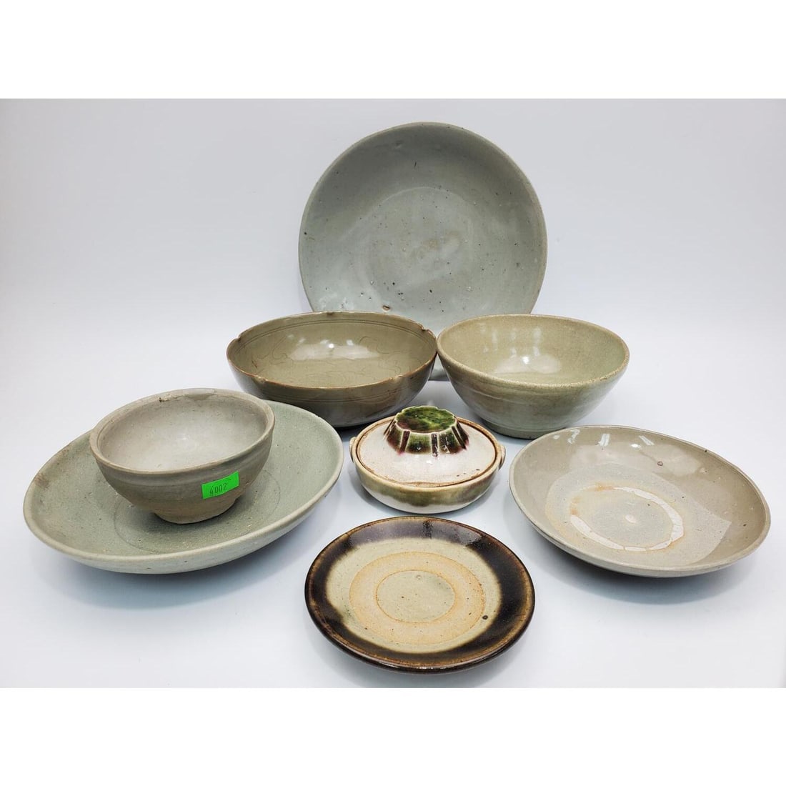 Lot of 8 Chinese Celadon Porcelain Bowls: Lot of 8 Chinese Celadon Porcelain Bowls. Condition: Generally Good. Dimensions: Largest-Dia-8.5" x H-1.75". Provenance: From a Long Island, NY Home. Please note the absence of a Condition Report does