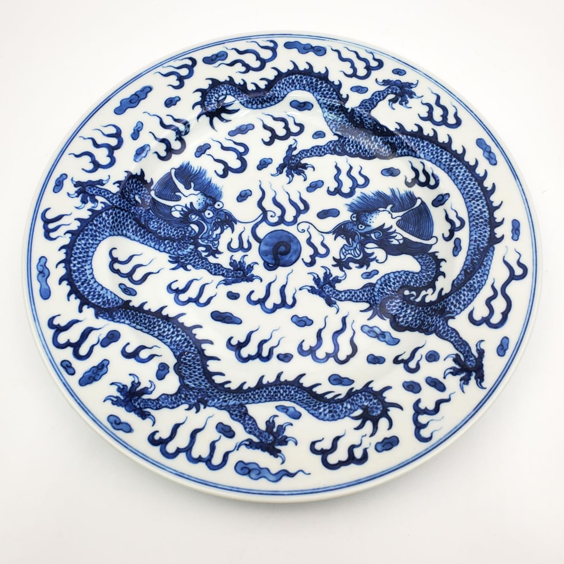 Chinese Blue & White Porcelain Plate: Chinese Blue & White Porcelain Plate Depicting 2 Dragons. Marked at the Bottom. Condition: Generally Very Good. Dimensions: Dia-9.25". Provenance: From a Long Island, NY Home. Please note the absence