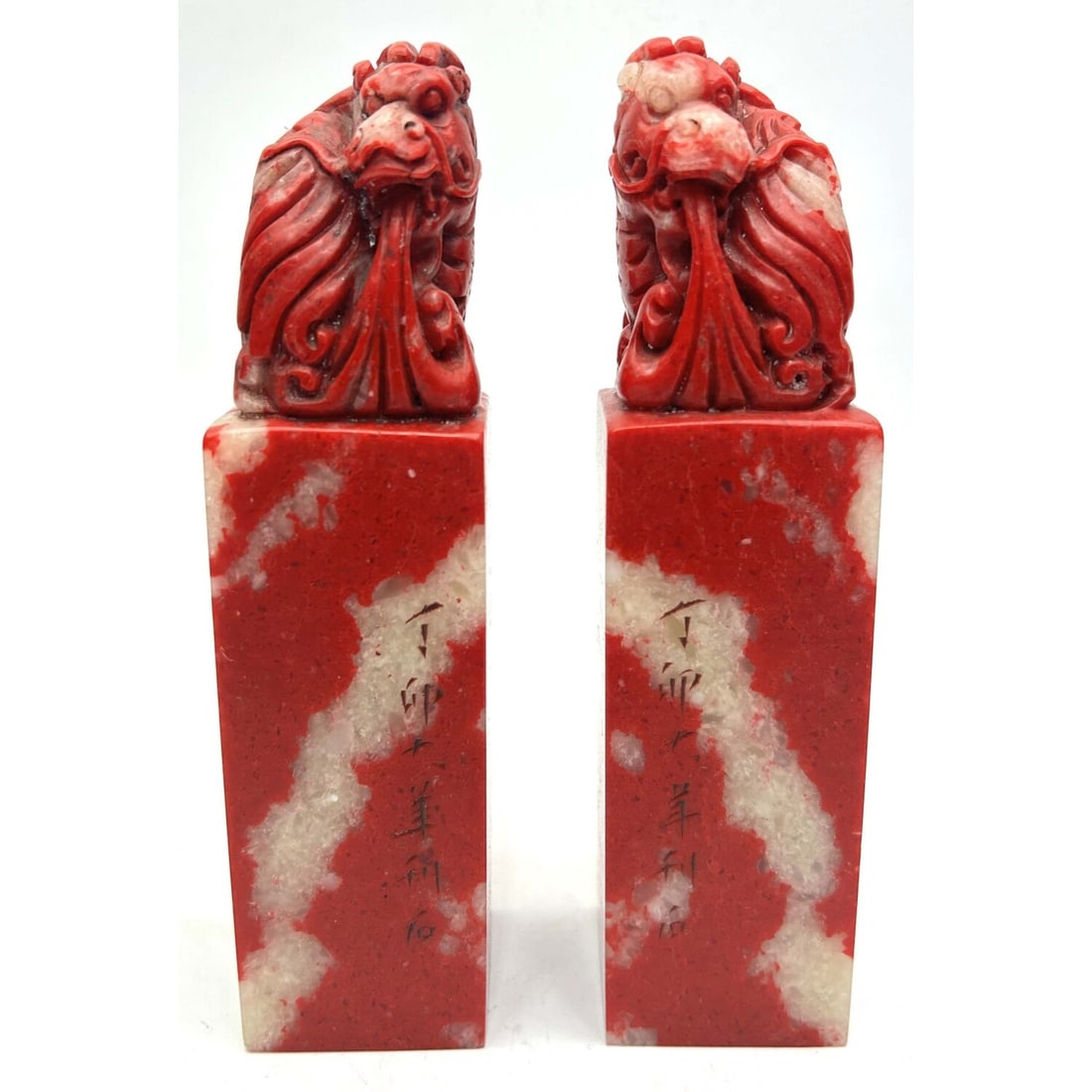 Pair of Chinese Carved Blood Hard Stone Seals: Pair of Chinese Carved Chicken Blood Hard Stone Seals or Stamps w/ Dragon Figures on Top. Condition: Generally Very Good. Dimensions: H-6.5" Each. Provenance: From a Long Island, NY Home. Please note