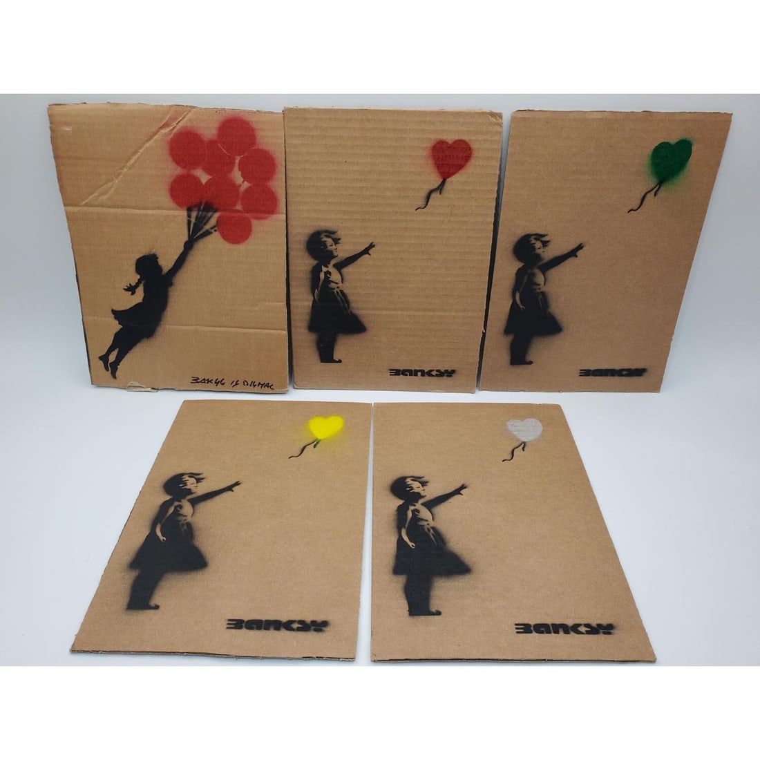 After Banksy, 5 Spray Paint Artworks: After Banksy, British, 5 Artworks, Spray Paint on Cardboard from "Dismaland" Exhibit. All Are Signed & Numbered w/ Dismaland Stamp on the Back. We Do Not Guarantee the Authenticity of This Item. Condi