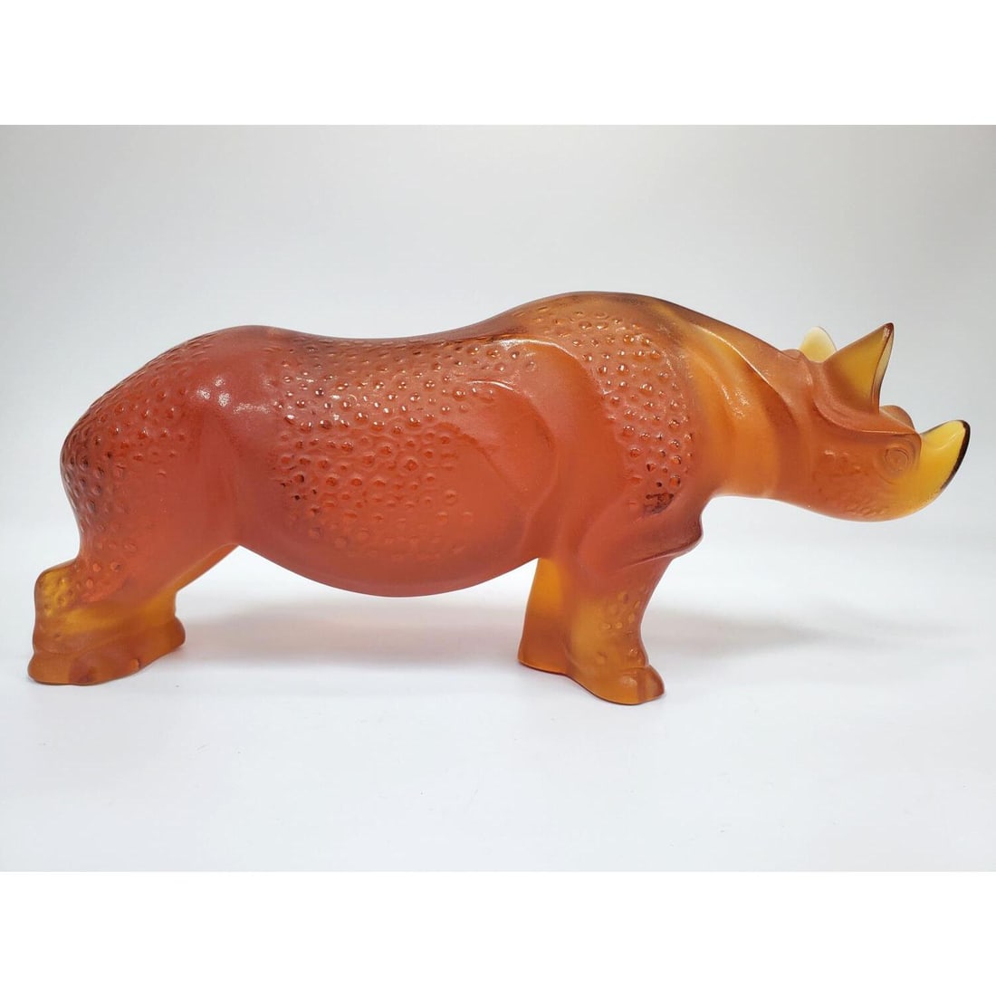 Lalique France "Toba" Rhino Amber Art Glass Figure: Lalique France Vintage "Toba" Rhinoceros Amber Art Glass Sculpture. Fully Signed. Condition: Excellent. Dimensions: L-10" x H-4.5". Provenance: From a New York City Apartment. Please note the absence