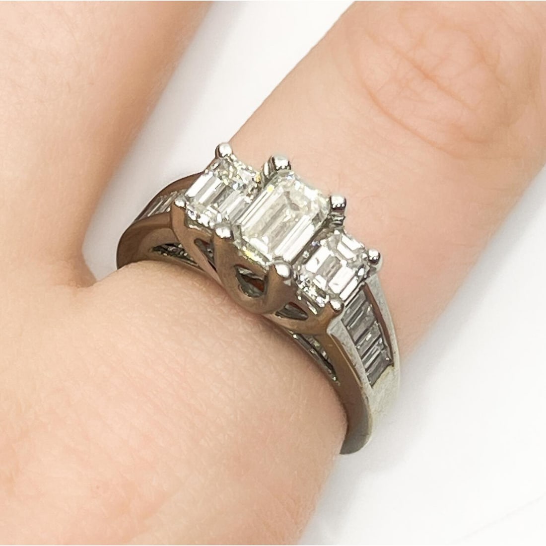 14K White Gold & Emerald Cut Diamond Ring: 14K White Gold & Emerald Cut Diamond Ring. The Center Emerald Cut Diamond is 0.85 Carats & 1.2 Carats Total of Diamonds on The Sides. Color is G-H & Clarity is SI1. Comes w/ GIA Certificate. Please No