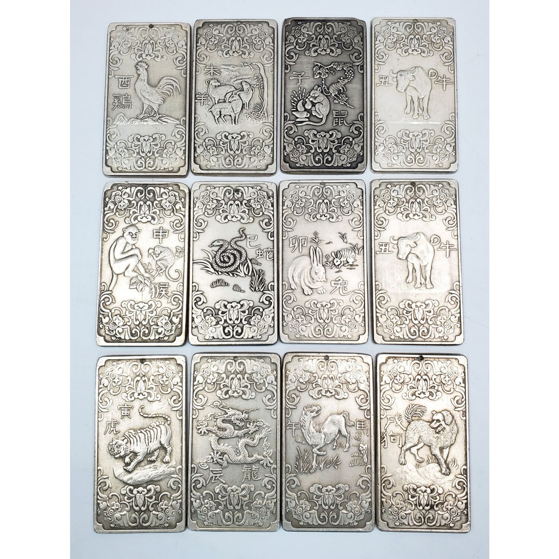 Lot of 12 Vintage Chinese Zodiac Amulets: Lot of 12 Vintage Chinese Zodiac Amulets. Condition: Generally Very Good. Dimensions: Each-3.75" x 2". Provenance: From a Long Island, NY Home. Please note the absence of a Condition Report does not i