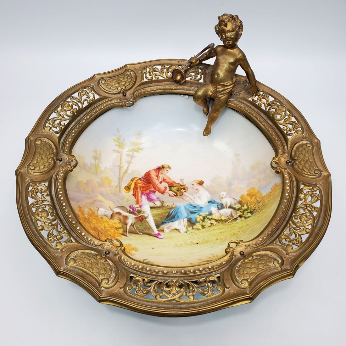 Antique 19th C. Sevres Style Large Porcelain Bowl: Antique 19th C. Sevres Style Large Porcelain Bowl w/ Original Heavy Bronze Mount. Condition: Excellent. Dimensions: Dia-4" x Total H.-7" Including The Cherub. Provenance: From a Long Island, NY Home. 