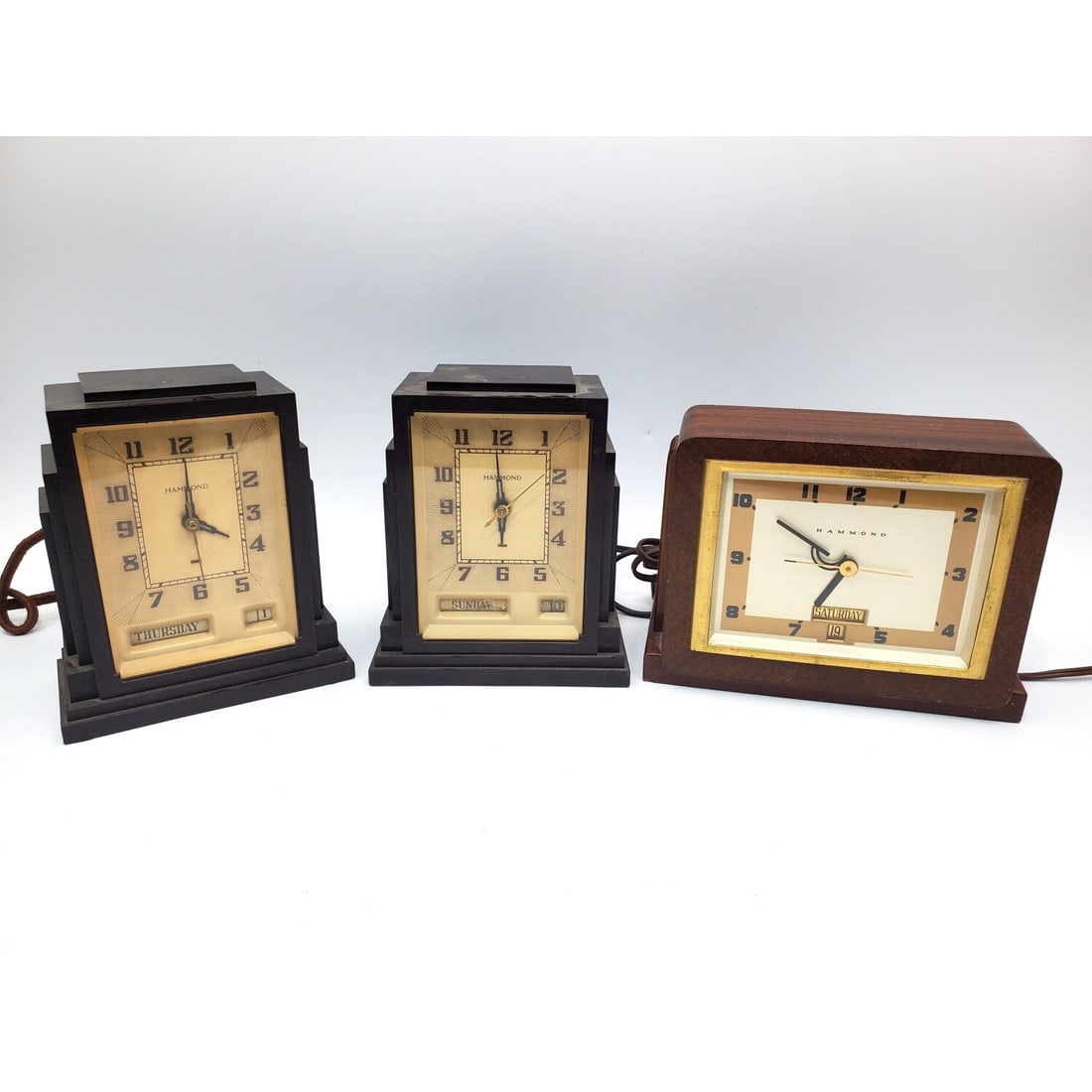 Pair of Hammond Gregory Art Deco Clocks: Pair of Hammond Gregory Art Deco Skyscraper Bakelite Clocks. Along w/ Another Hammond Alarm Clock. All Are c.1930's. Condition: Generally Good. Please Note- We Do Not Guarantee the Workability of Old 