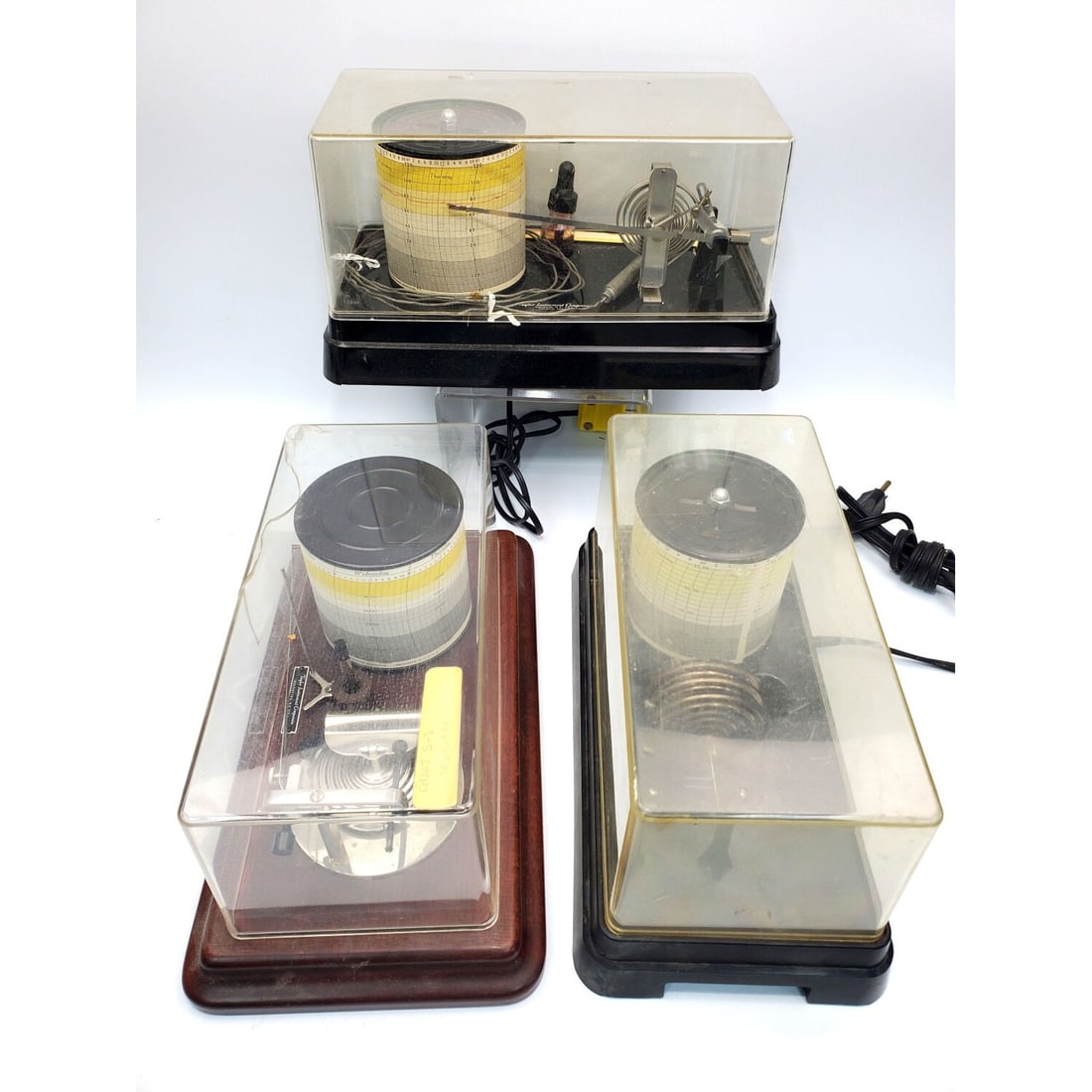 3 Vintage Taylor Instrument Companies Barographs: Lot of 3 Vintage Taylor Instrument Companies Barographs w/ Protective Plastic Covers. Comes w/ a Book "Barographs" by Philip R. Collins & Additional Paper. One Barograph Comes w/ Original Box. Conditi