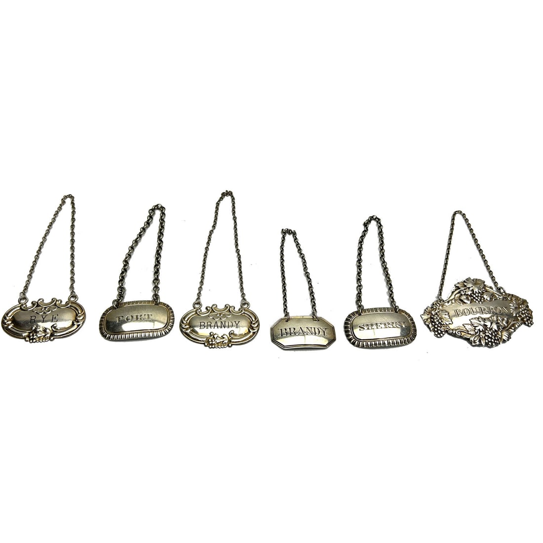 Lot 6 Antique English Sterling Silver Tags: Lot of 6 Antique English Sterling Silver Tags.Condition: Generally Good. Dimensions: Largest-L-3" x H-2". Gross Weight: 73.4g/2.3ozt. Provenance: From a Long Island, NY Home. Please note the absence o