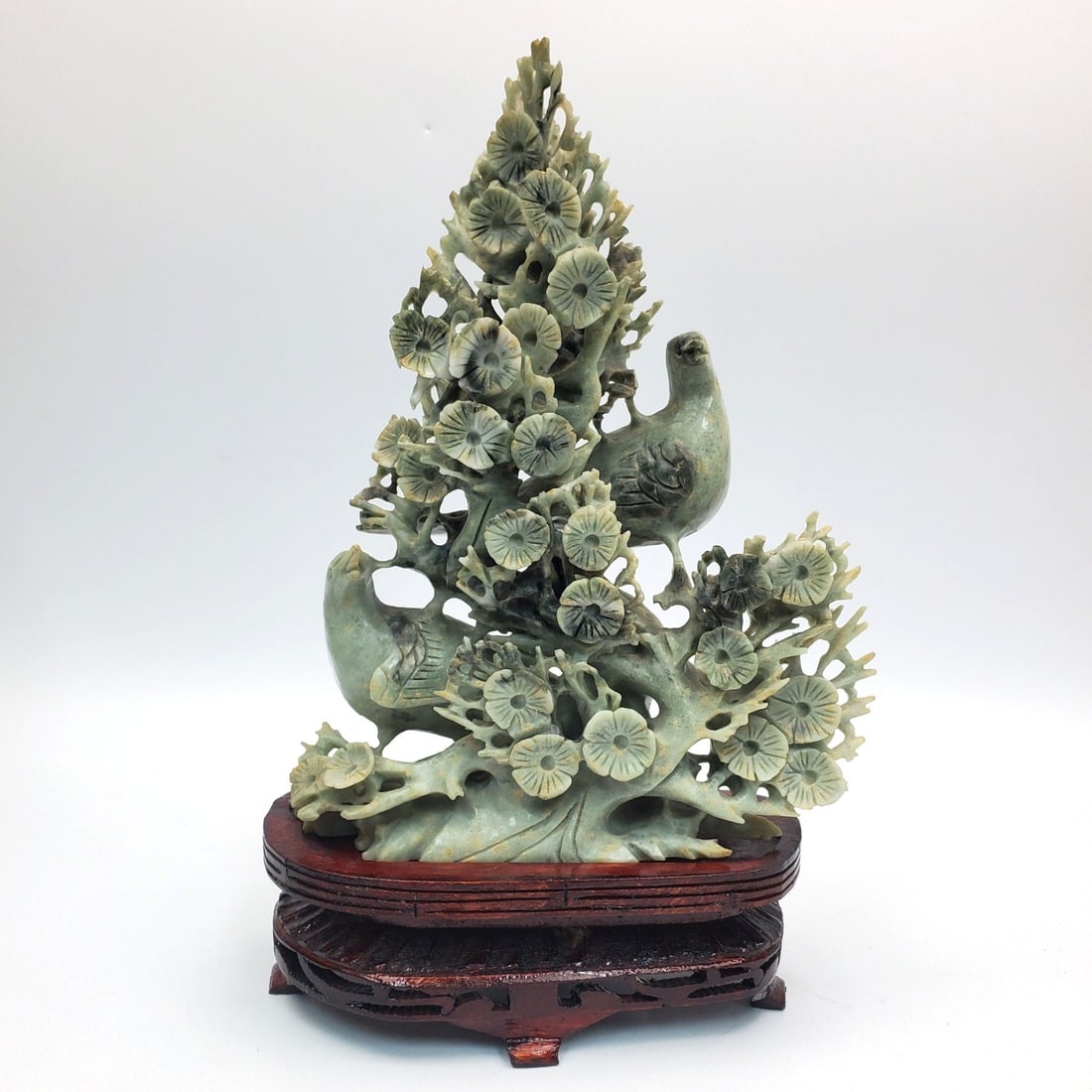 Chinese Very Fine Carved Green Hard Stone Figure: Chinese Very Fine Carved Green Hard Stone Figure Depicting Pheasants & Flowers. On Original Wood Base. Condition: Generally Very Good. Dimensions: Carving-H-9.25. Base-L-6.5". Provenance: From a Long 
