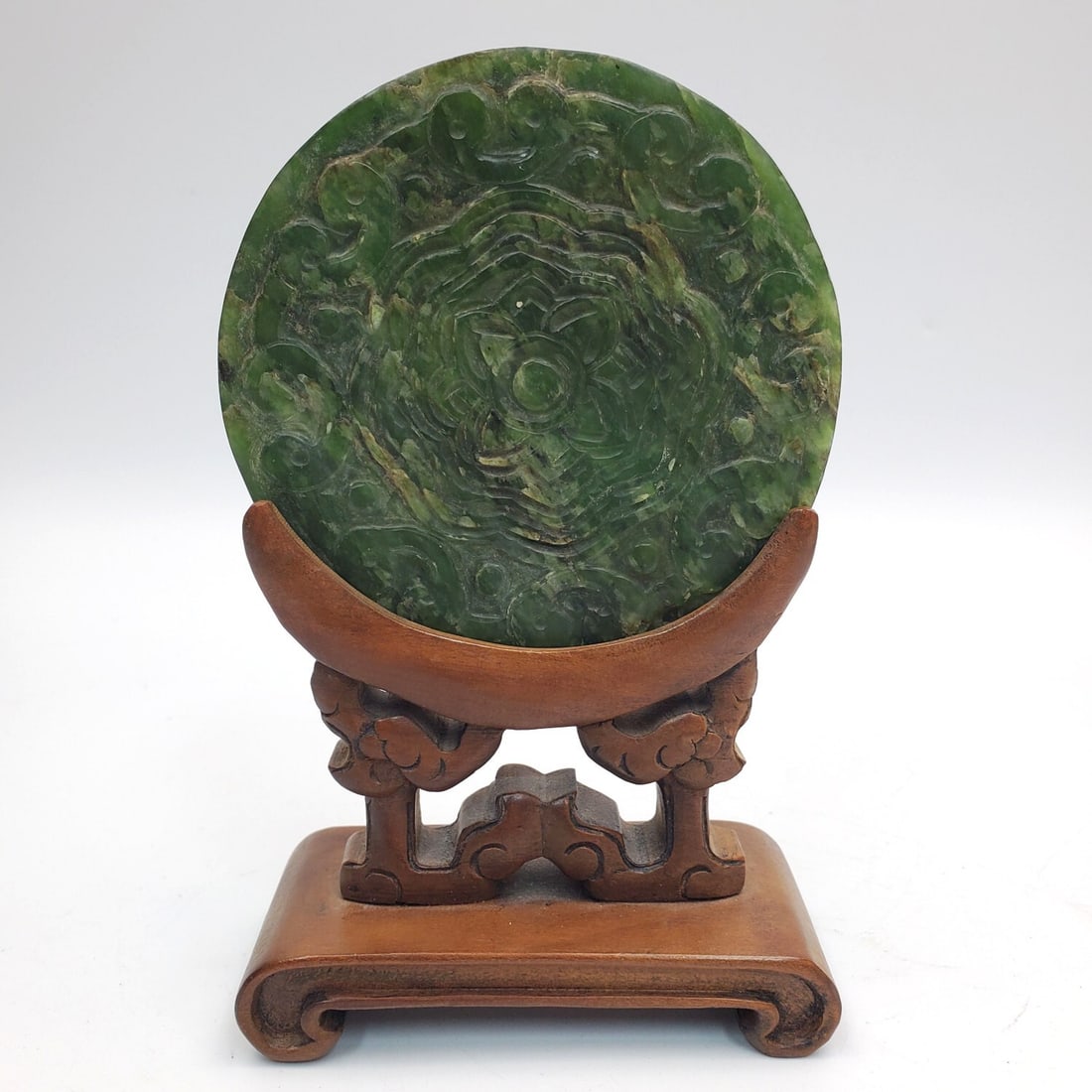 Chinese Carved Jade Plaque on Original Wood Base: Chinese Carved Jade Plaque on Original Wood Base. Condition: Generally Very Good. Dimensions: Jade-Dia-4". Base-L-4". Provenance: From a Long Island, NY Home. Please note the absence of a Condition Re